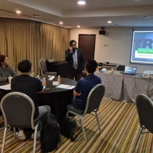 Trainer presenting accountability workshop to participants in meeting room