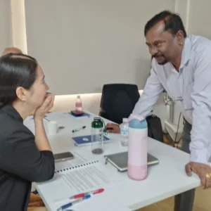 Trainer mentoring participant during workshop session
