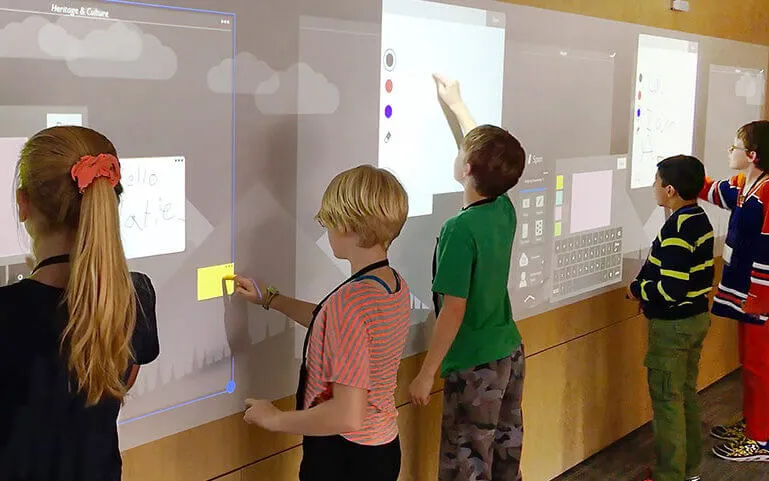 Students using interactive digital classroom board